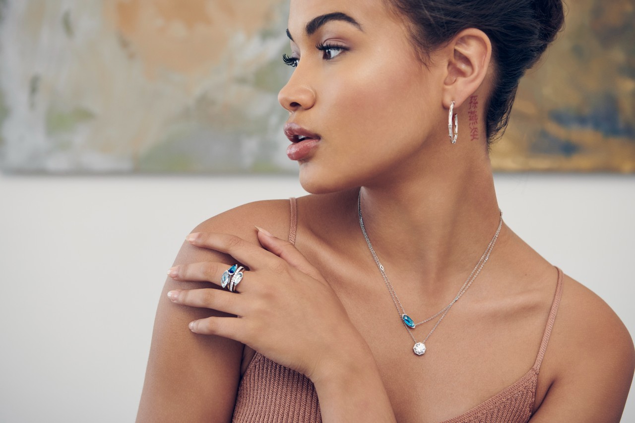 a woman looking away from the camera wearing TACORI jewelry