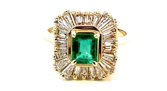 a yellow gold fashion ring featuring an emerald center stone and halo setting