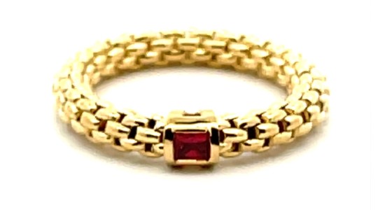 a yellow gold chain ring by Fope with a ruby center stone