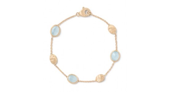 a yellow gold station bracelet featuring aquamarine accents