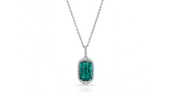 a white gold pendant necklace with a green tourmaline center stone