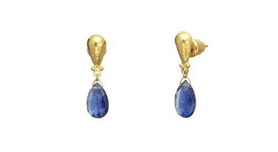 a pair of yellow gold drop earrings featuring blue pear shape gemstones