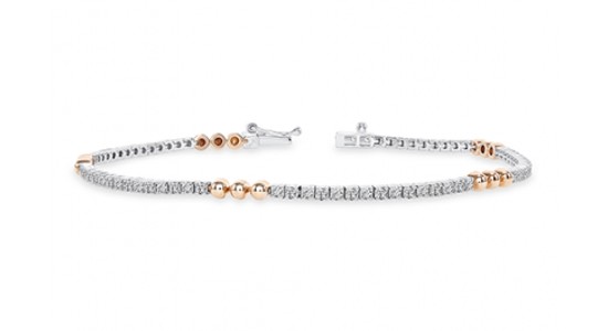 a mixed metal diamond tennis bracelet featuring rose gold spheres