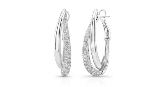 a pair of white gold sculptural hoop earrings with diamond accents.