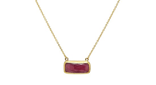 a yellow gold pendant necklace with a ruby center stone