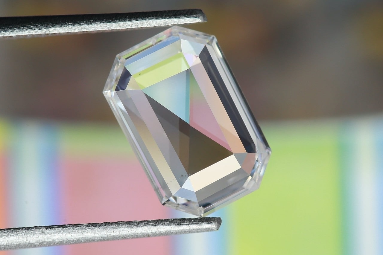 an emerald-cut diamond being held between two prongs